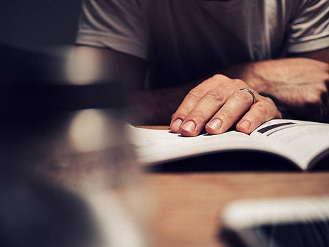 Man reading a watch manual