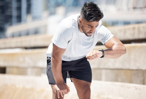 man running looking at his watch