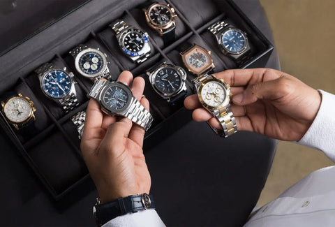 Man keeping his watches in a watch box