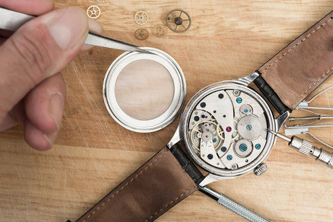 Watchmaker repairing a watch