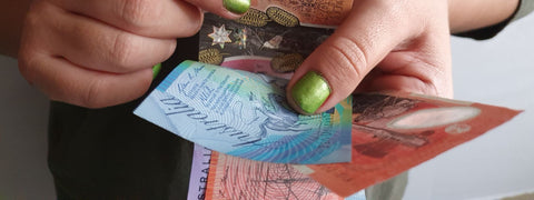 woman holding Australian money