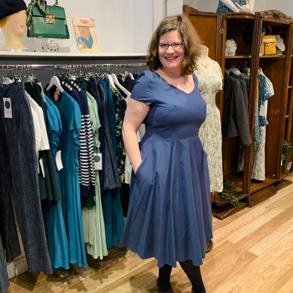 choosing sustainable shopping with revival retro, a woman wears a blue organic cotton dress from our own range