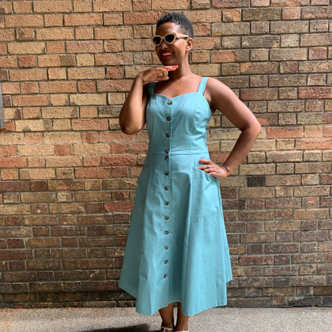 Woman in blue sundress with buttons and pockets