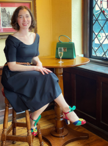 Woman sitting in black dress