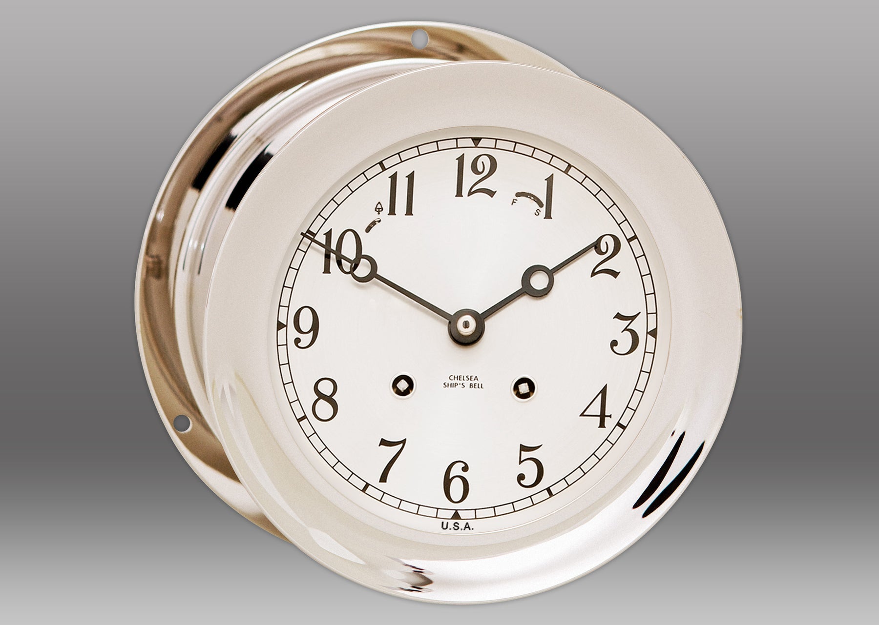 A white clock with black hands Description automatically generated