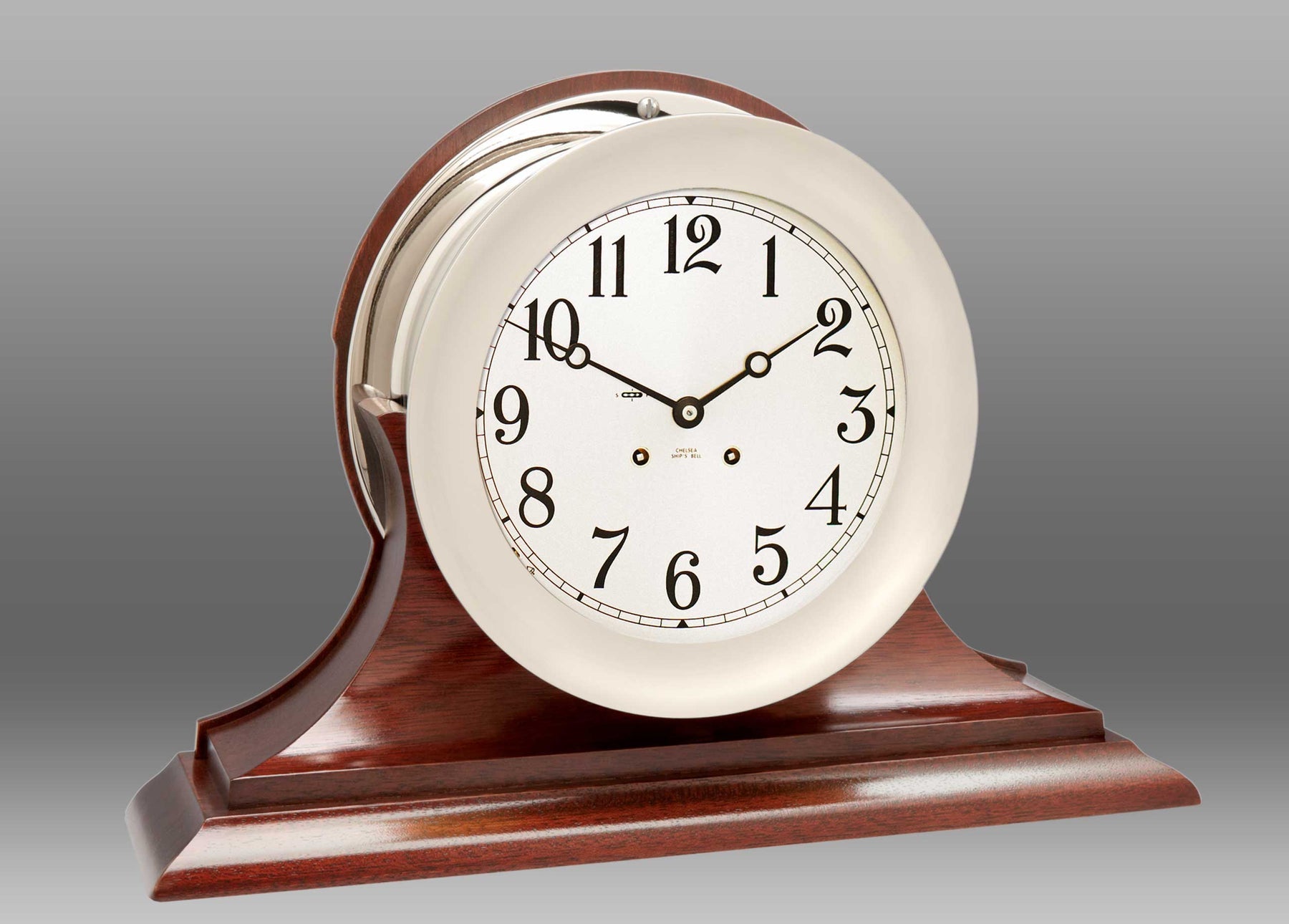 A clock on a wooden stand Description automatically generated