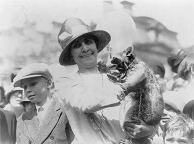 First Lady Coolidge with family pet raccoon
