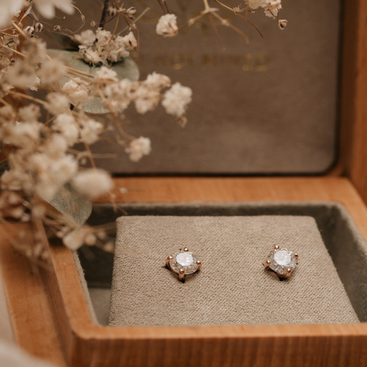 solitaire diamond style earrings in wooden box