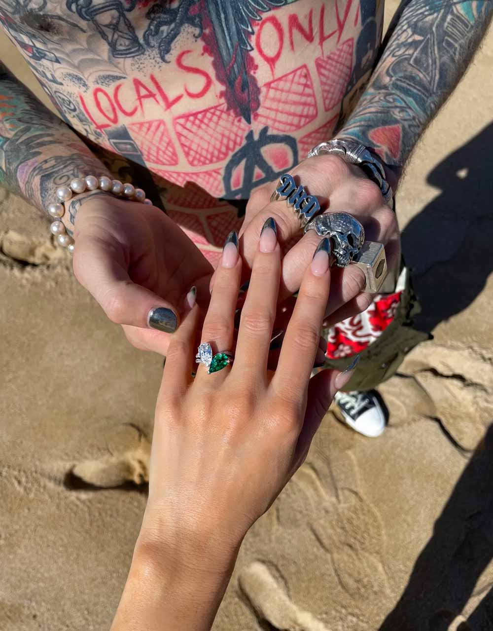 Photograph of Megan Fox's engagement ring taken by Megan from above as she holds her hand out into Machine Gun Kelly's hands.