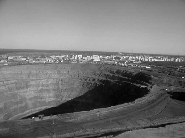 Black and white photograph of Mirny Diamond Mine in Russia which holds the fourth position for depth among the world’s open pit mines.