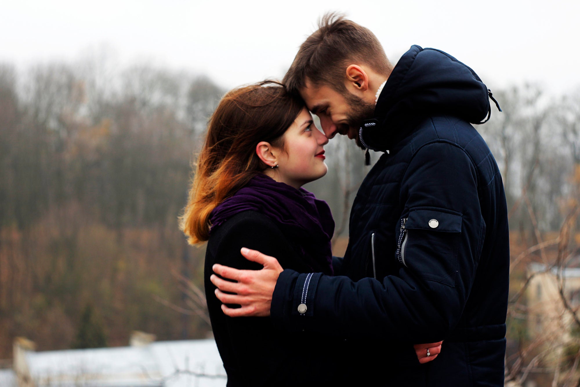 couple with heads together in a wintry place