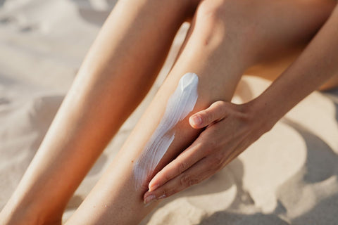 A person sitting on beach using handmade suncreen