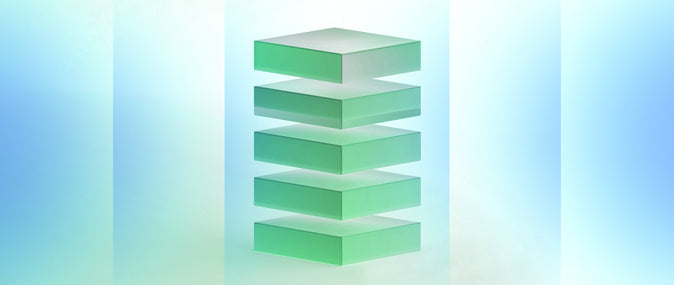 Stack of green translucent blocks ascending in size on a gradient background.