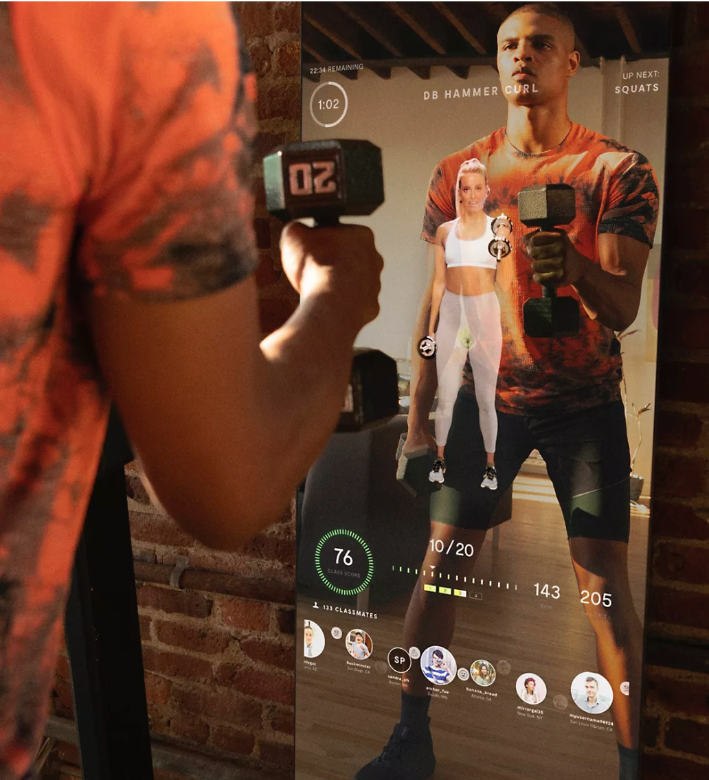 Man lifting weights while using Lululemon’s interactive mirror