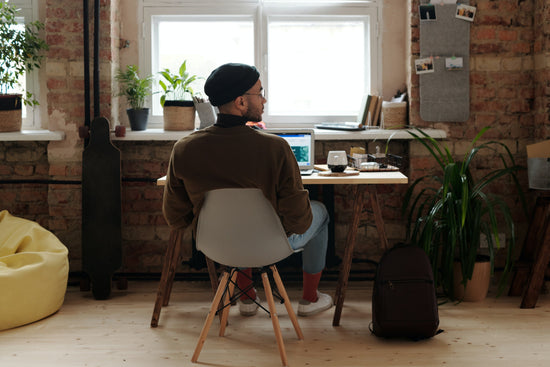 Entrepreneur working at a desk, part of the '30 Ways to Make $2000 a Month' guide for financial freedom