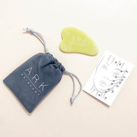 ARK Skincare's Jade tool with a grey pouch and how-to guide