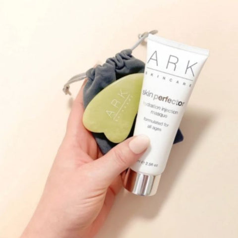 Product Image: ARK Skincare's Facial Massage Set Including: Hydration Injection Masque & Jade Tool with a velvet pouch.