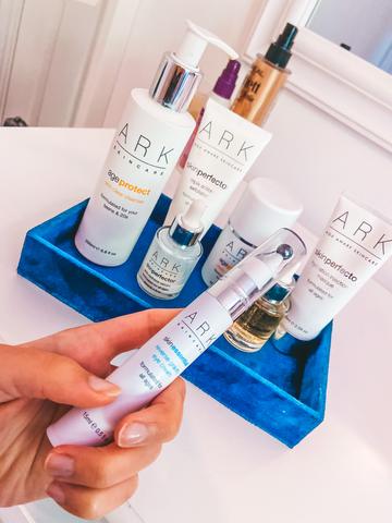 A selection of ARK Skincare products on a dressing table