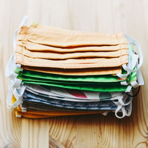 Image: Pile of different coloured reusable cotton face masks