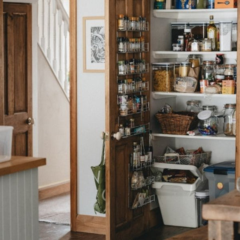 The inside of a pantry with a selection of different food and snacks