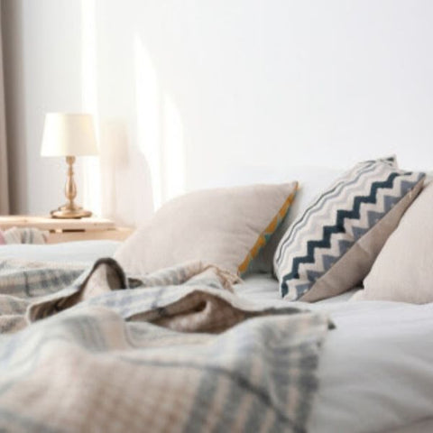 Bedroom with an unmade bed with pillows and blankets