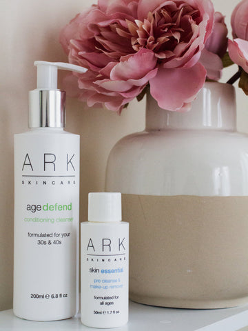 ARK Skincare's Age Defend Range next to pink flowers in a vase