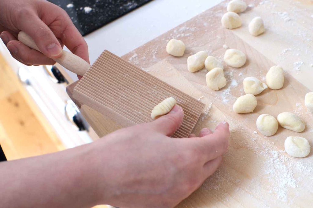 shaping gnocchi with a gnocchi board
