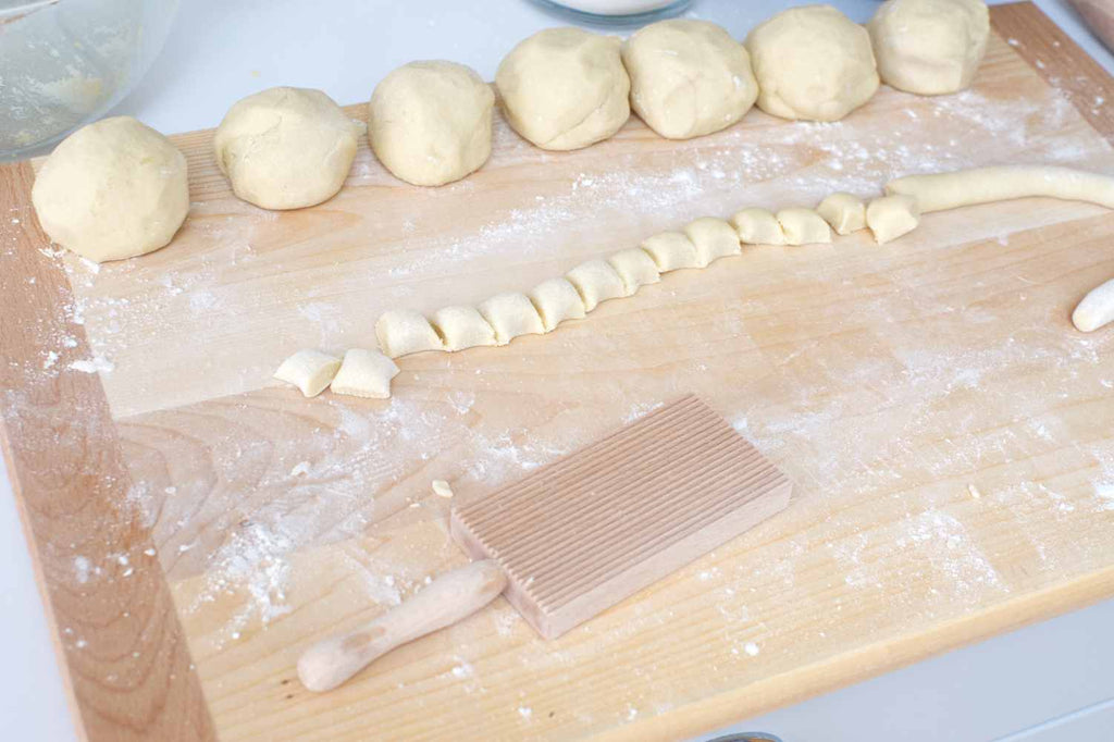 cutting gnocchi into small dumplings