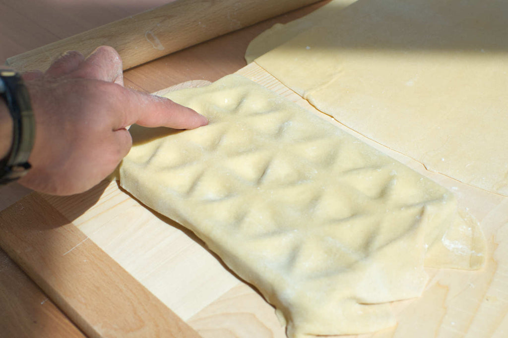 Creating divots in pasta sheet for ravioli filling