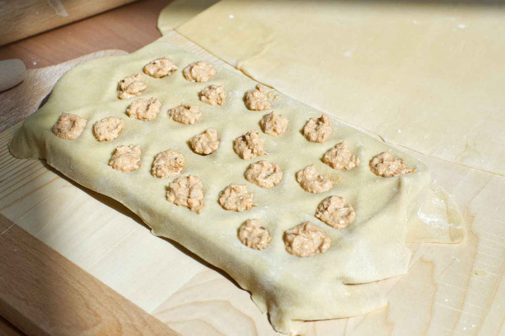 Filling ravioli with crab and ricotta mix