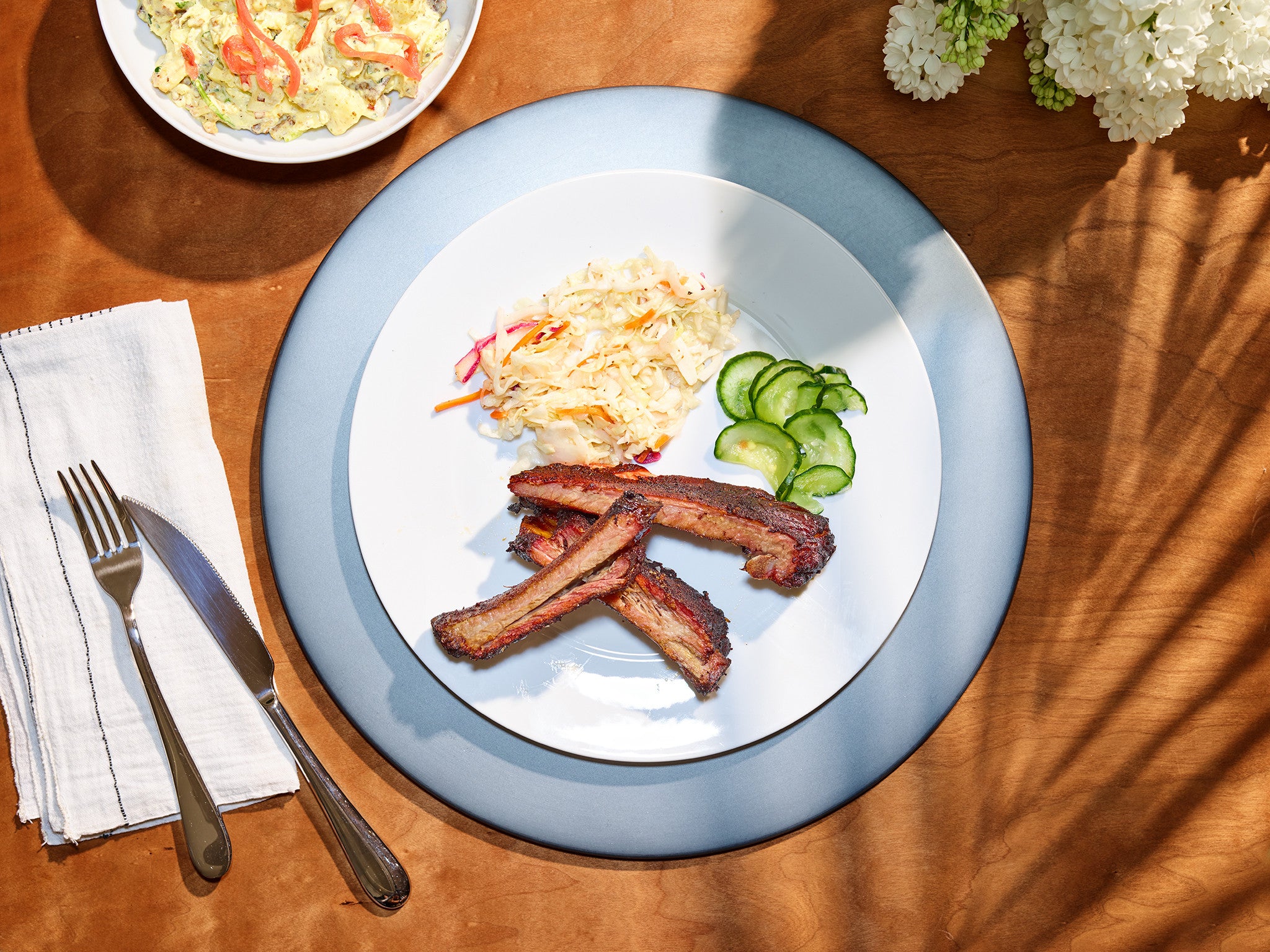 ribs and cucumber salad on a plate