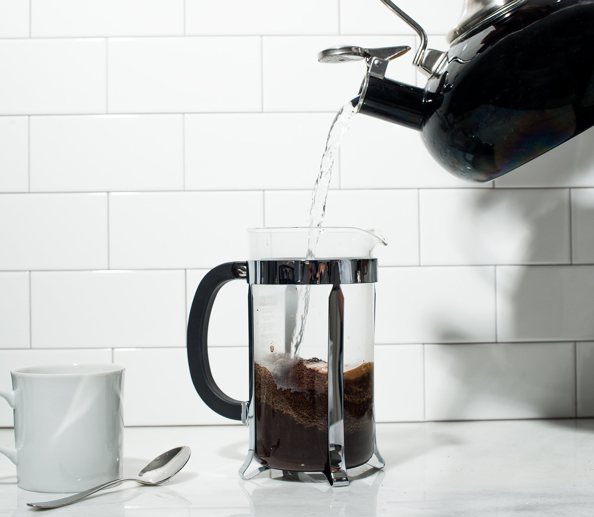 Pour water over the coffee grounds to saturate them first. 