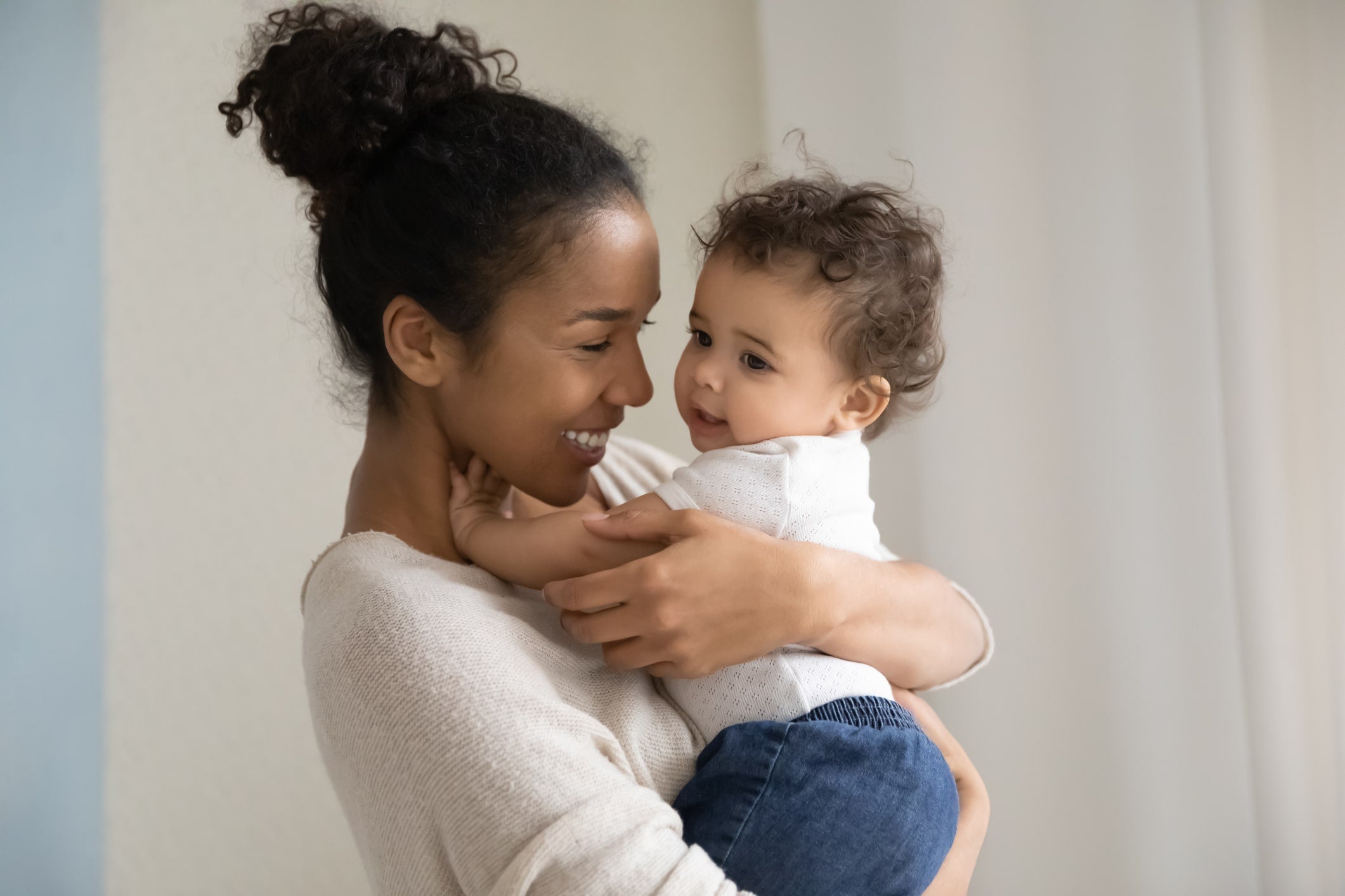 Young mother learning how to help baby sleep when teething