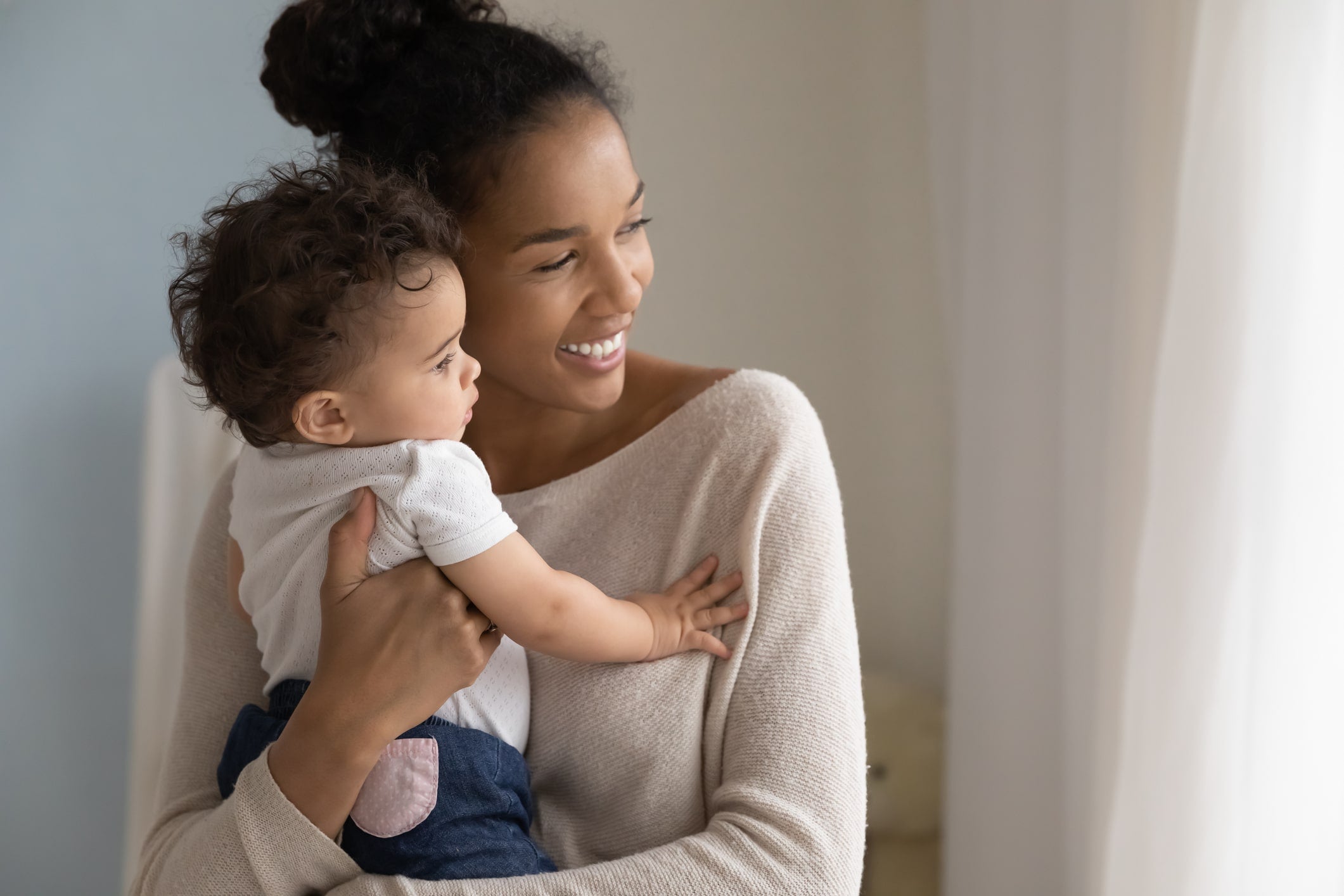 Young mother learning how to help baby connect sleep cycles at night