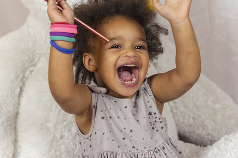 child during photoshoot with parents