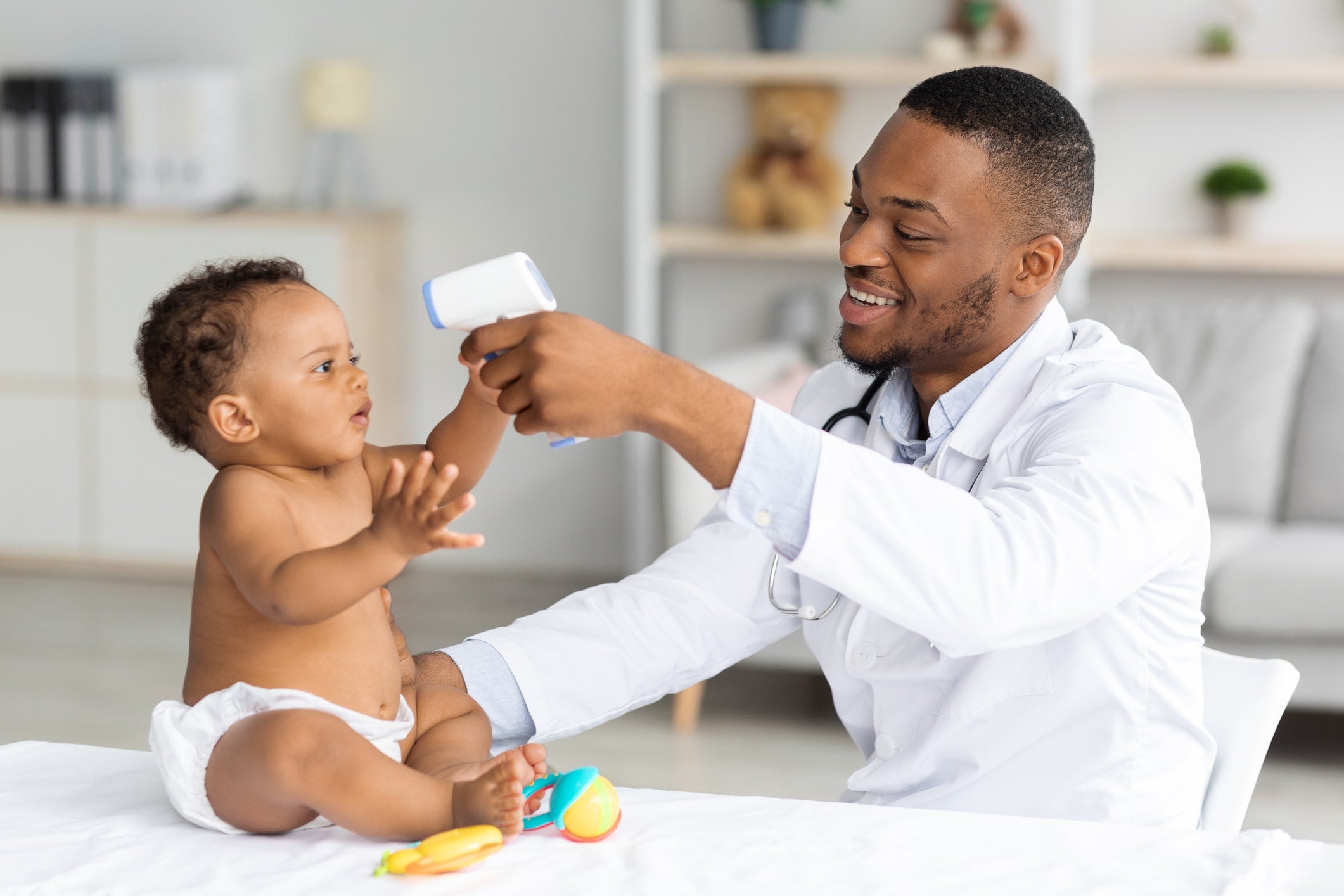 Doctor checking on baby sweating at night