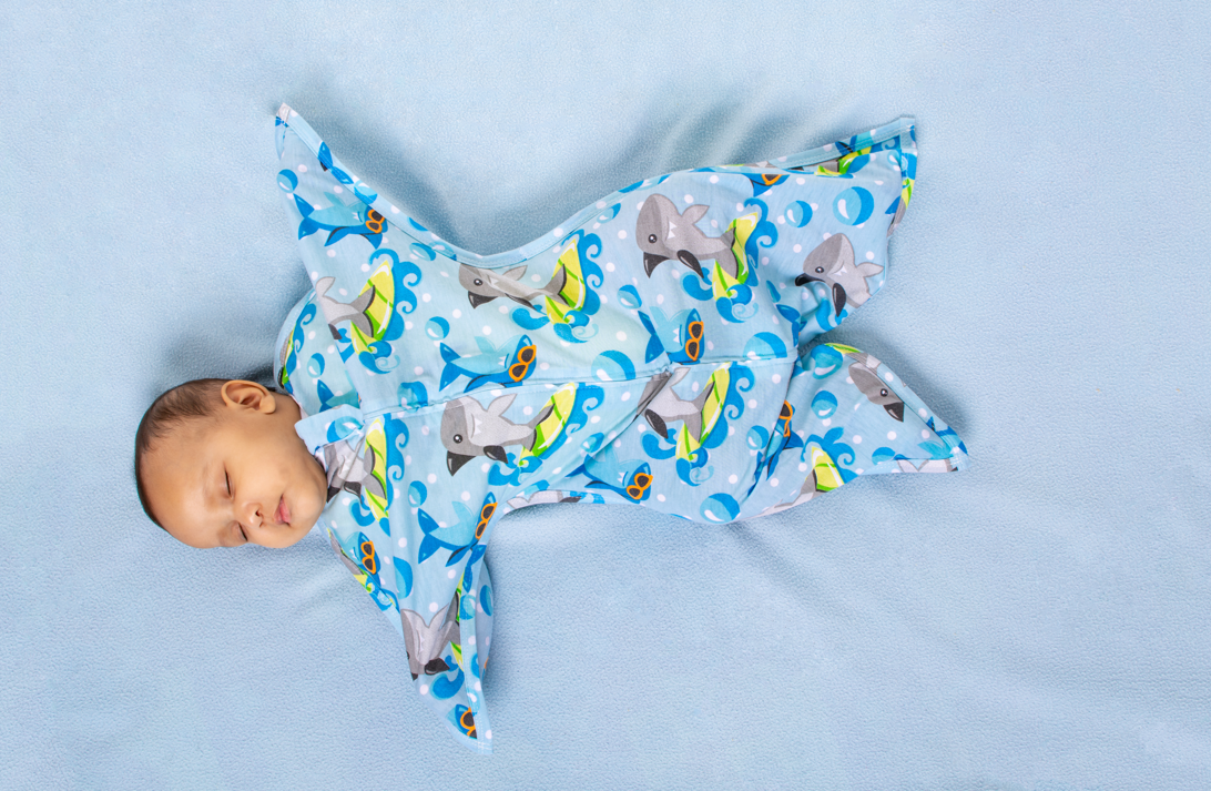 Baby in Zipadee-Zip transitioning from swaddle to sleep sack