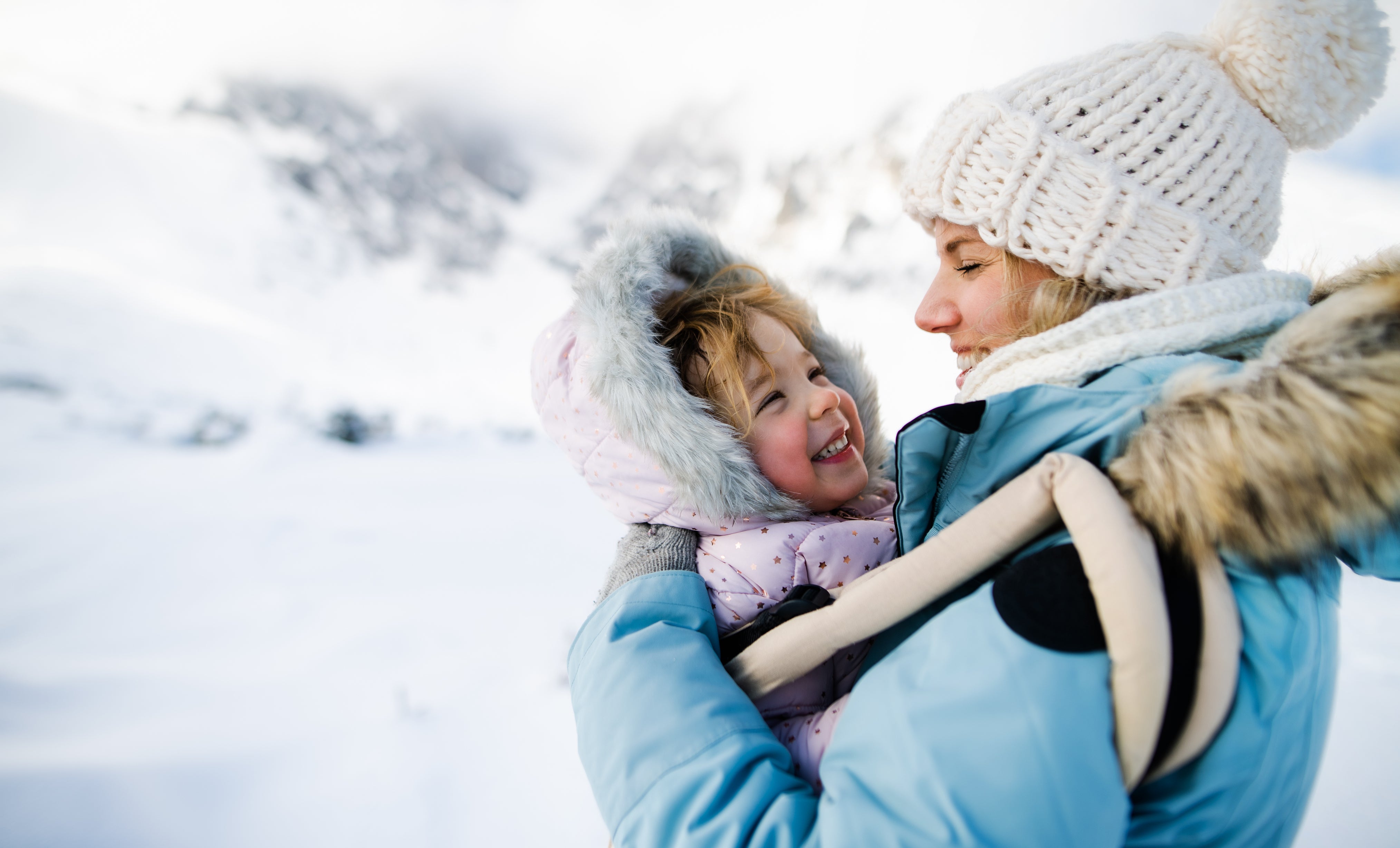 Dad with baby in cold weather while baby wears a warm bodysuit