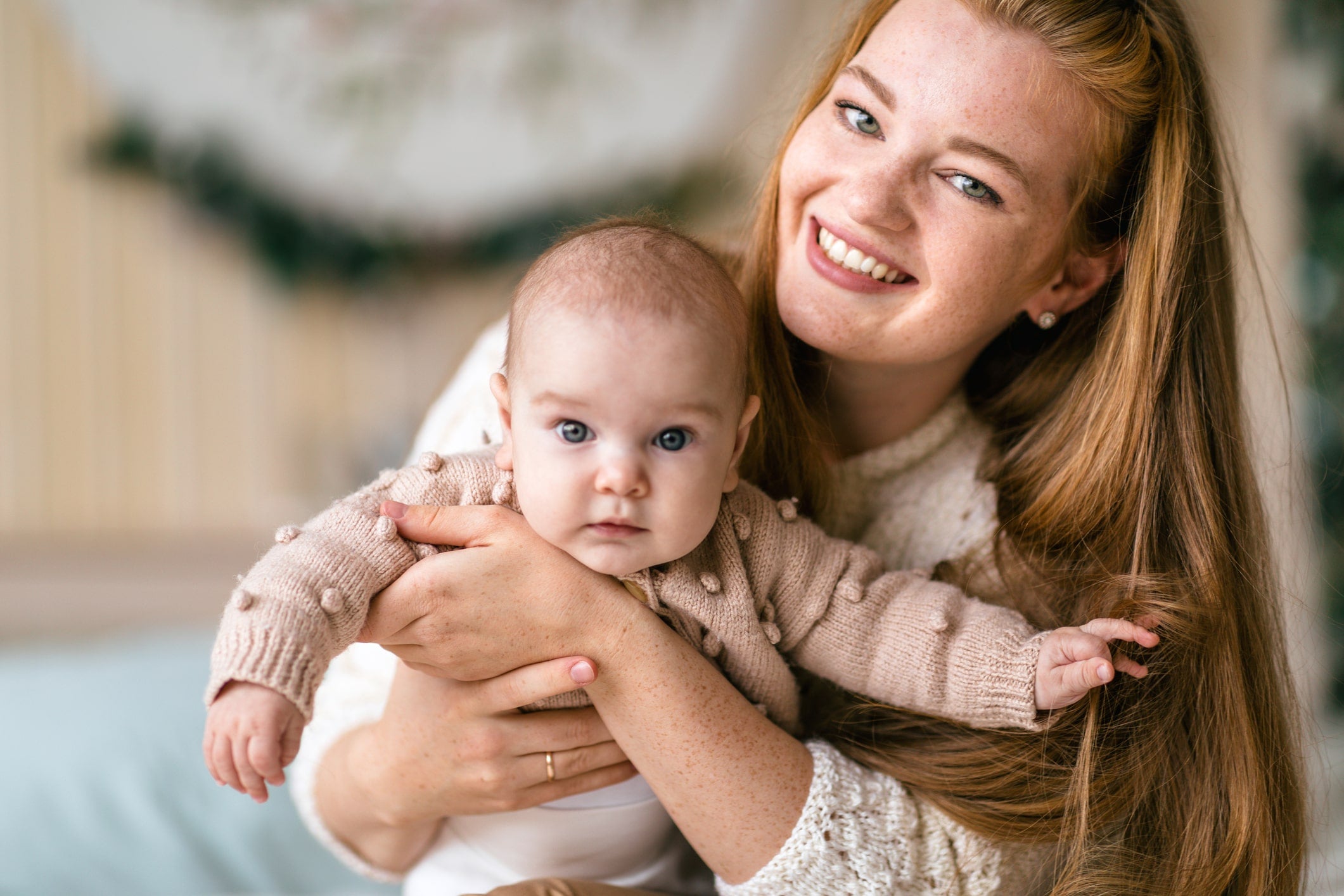 Mother holding baby suffering from hay fever in babies