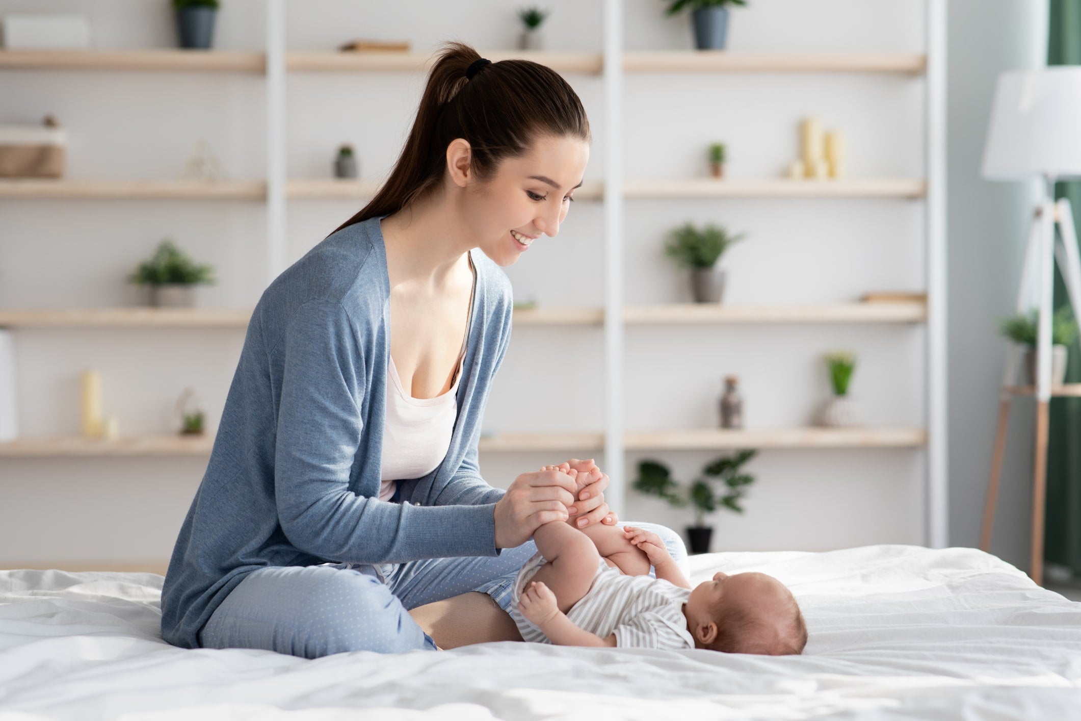 Mother with infant in best sleeping position for gassy baby