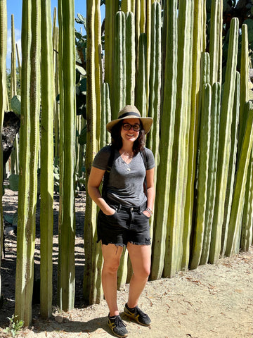 Brandy in front of tall cacti