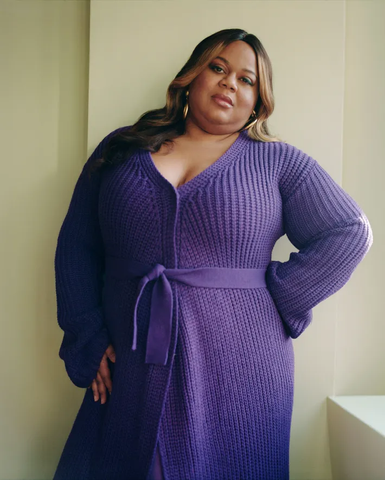 Reesa Teesa wears purple knit dress and Ben-Amun earrings for The Cut