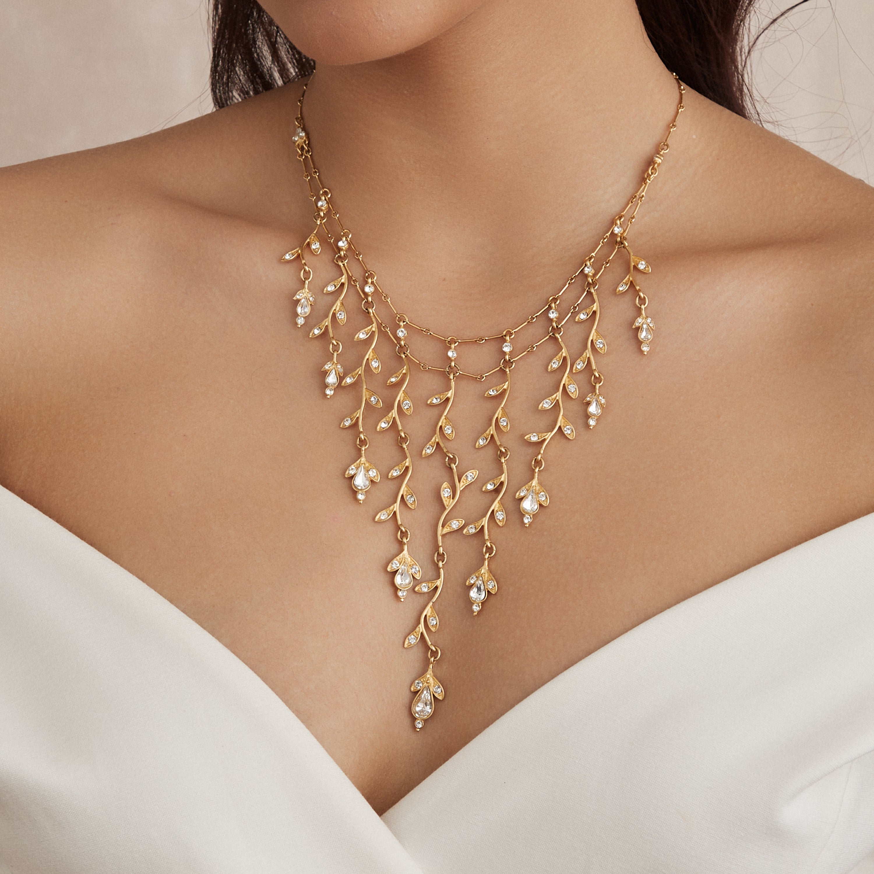 Woman wearing gold and crystal necklace