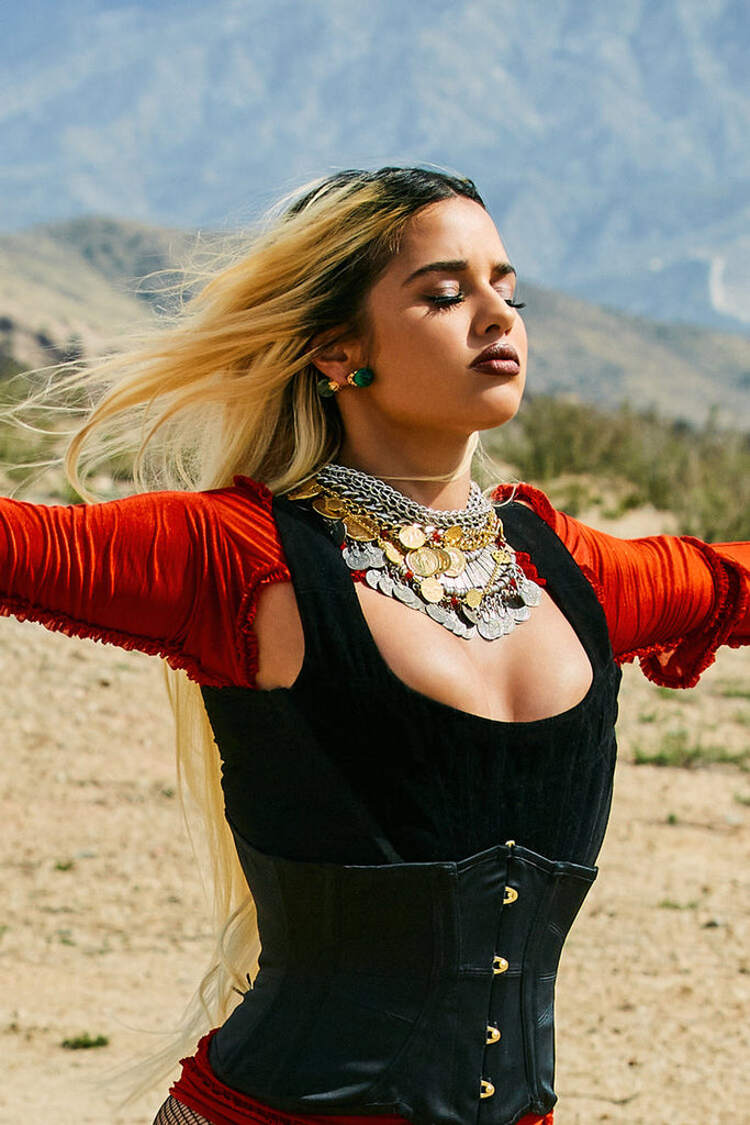 Tommy Genesis with eyes closed wearing ben-amun