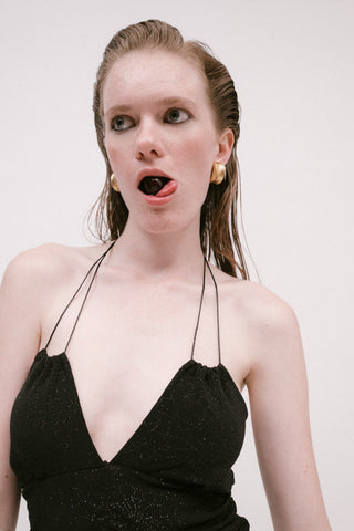 Woman poses in gold earrings from Ben-Amun with black dress for The Forumist