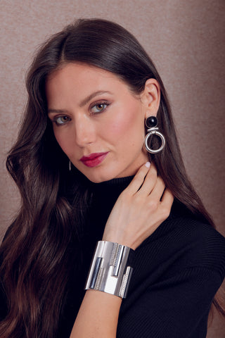 Model poses in silver jewelry from Ben-Amun's Miss Cosmopolitan Collection