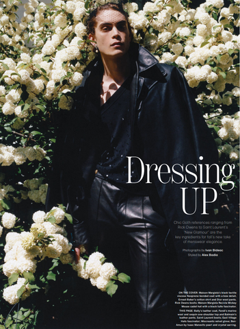 WWD Dressing Up cover featuring male model standing in white flowers with black outfit and one Ben-Amun earring