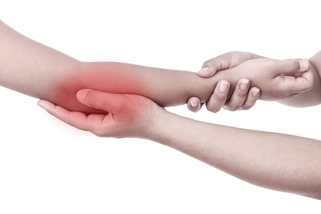 Woman's Hand Holding Children's Elbow. Elbow Pain Concept