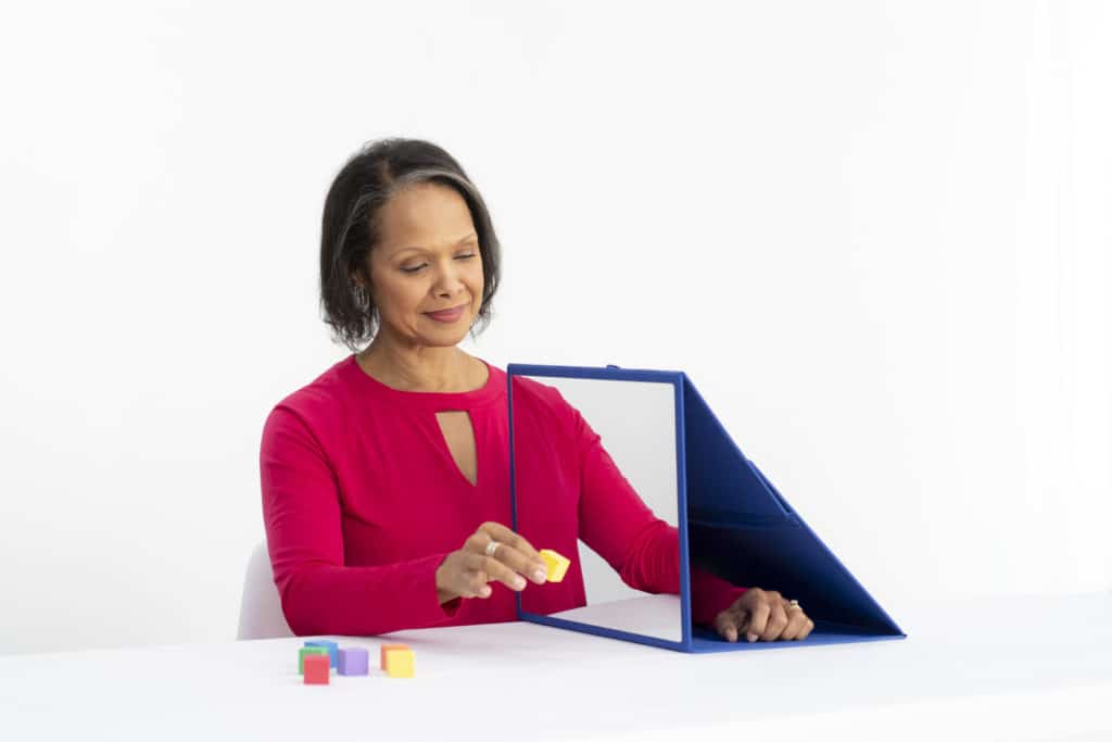 Woman Performing Exercises with Mirror Therapy - Saebo Mirror Box