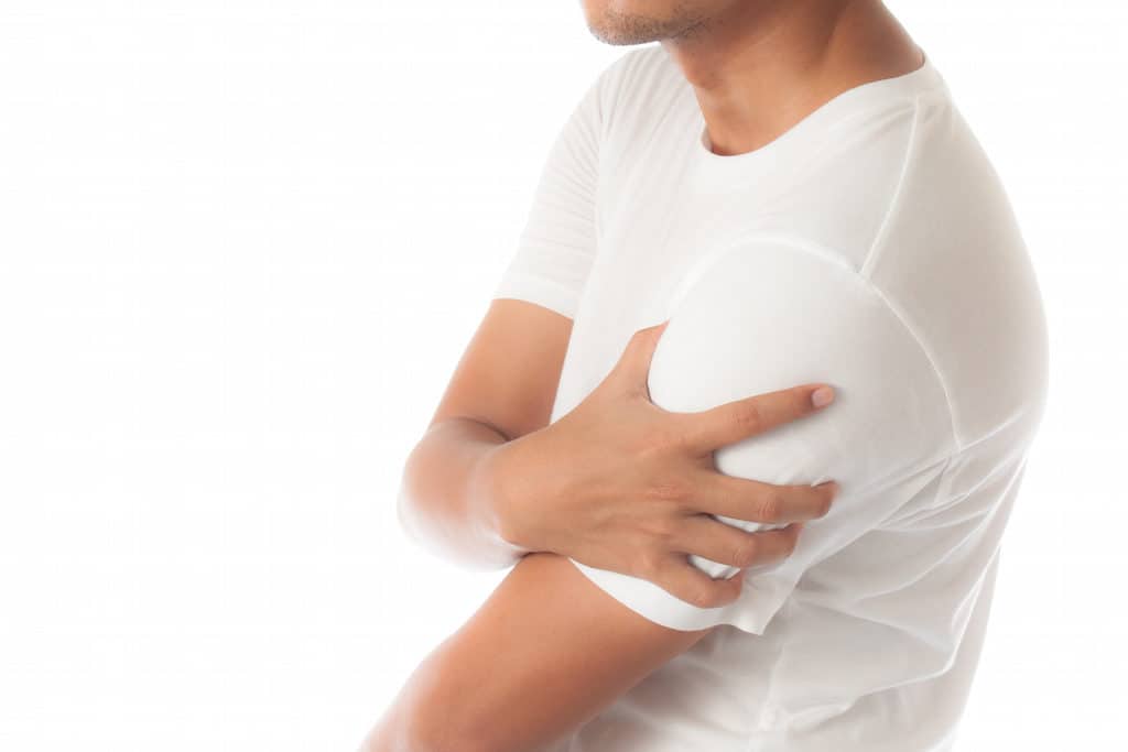 man having shoulder pain isolated on white background